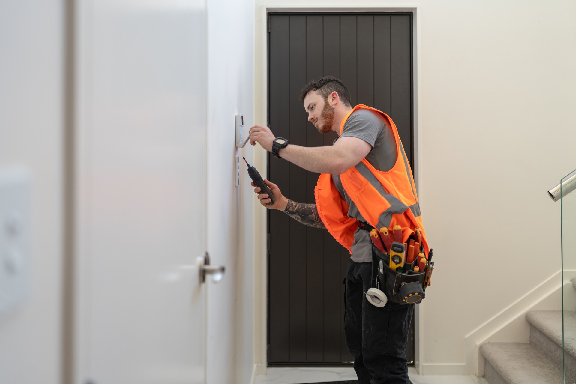 electrician installing security alarm